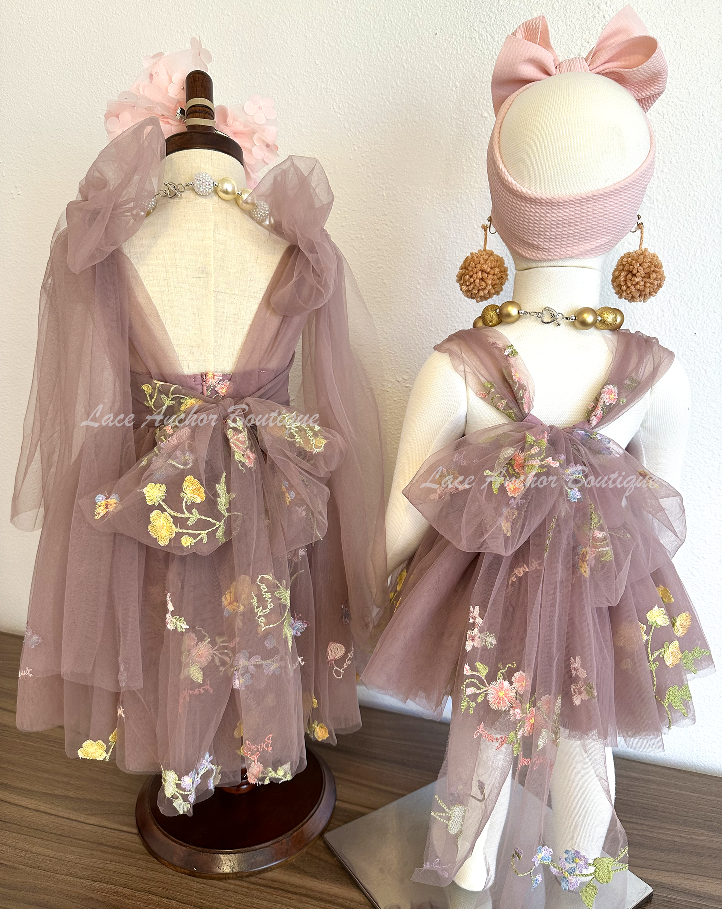 Baby girls romper with tied back fluffy bow. Outfits in deep plum purple with embroidered floral print.