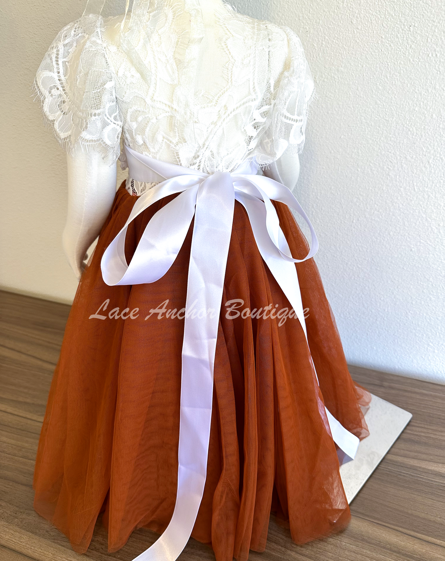 flower girls maxi dress with rust copper tulle skirt, white lace top with flutter sleeves, and white floral tied sash