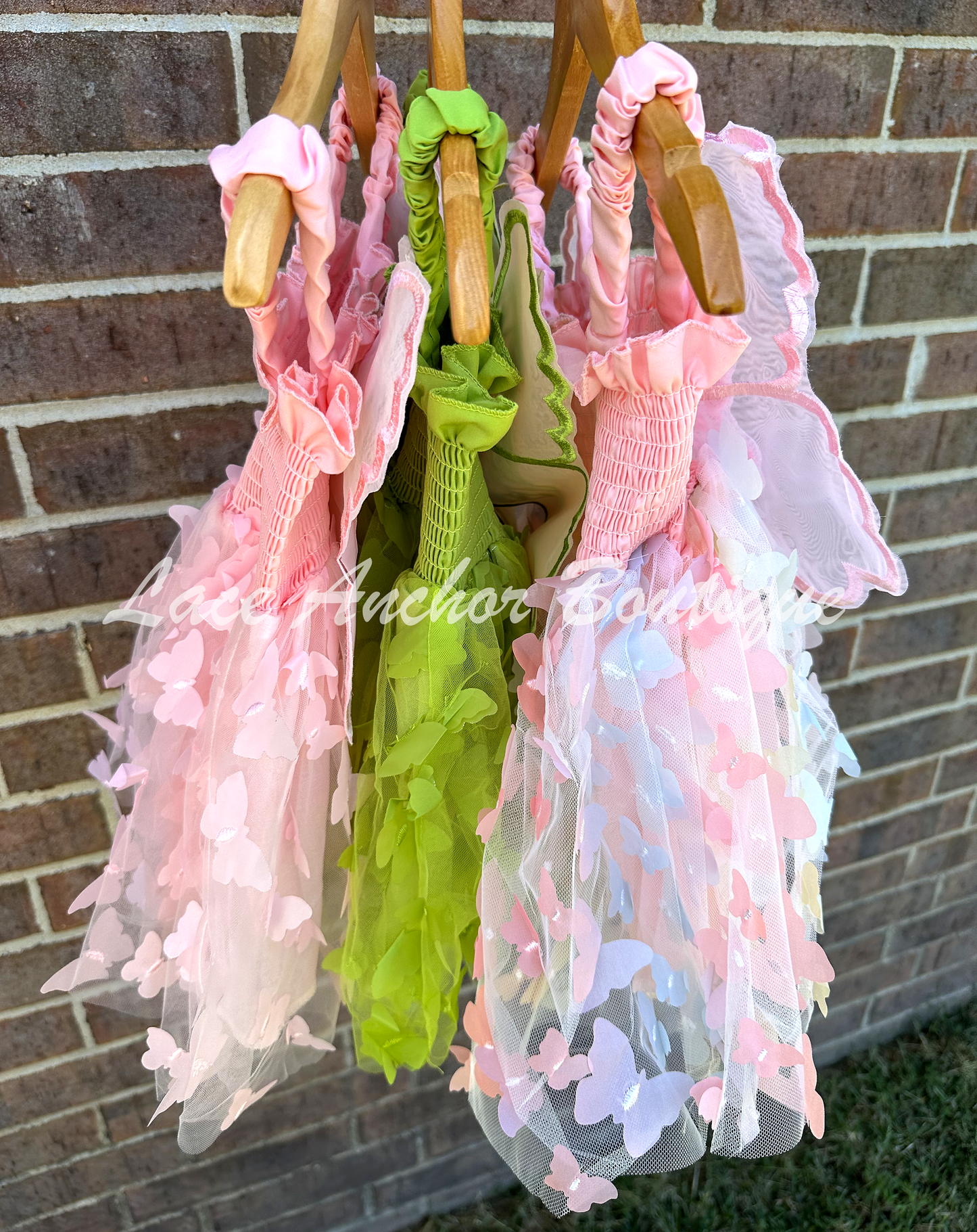 Girls butterfly wing dresses in pink, rainbow, and green. Attached fairy wings toddler baby dress.