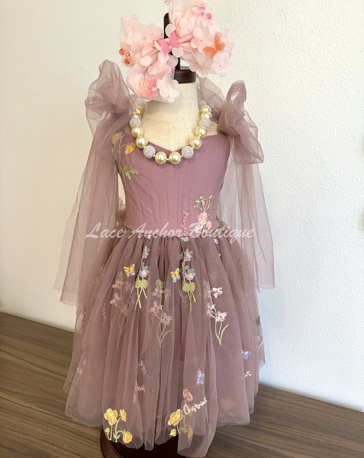 toddler youth puffy tied shoulder flower girl dress with large tied bow tied at waist. Outfits in deep plum purple with embroidered floral print.