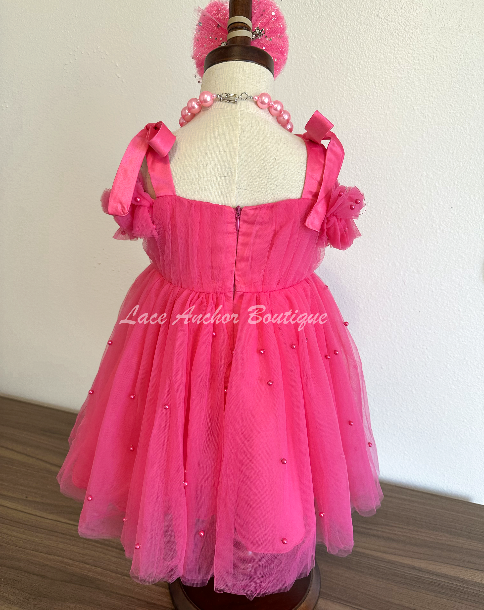 hot pink tulle princess birthday girl dress with pink pearls and bow tied shoulders with ruffled off shoulder sleeves. Baby toddler youth girls tutu party dress.