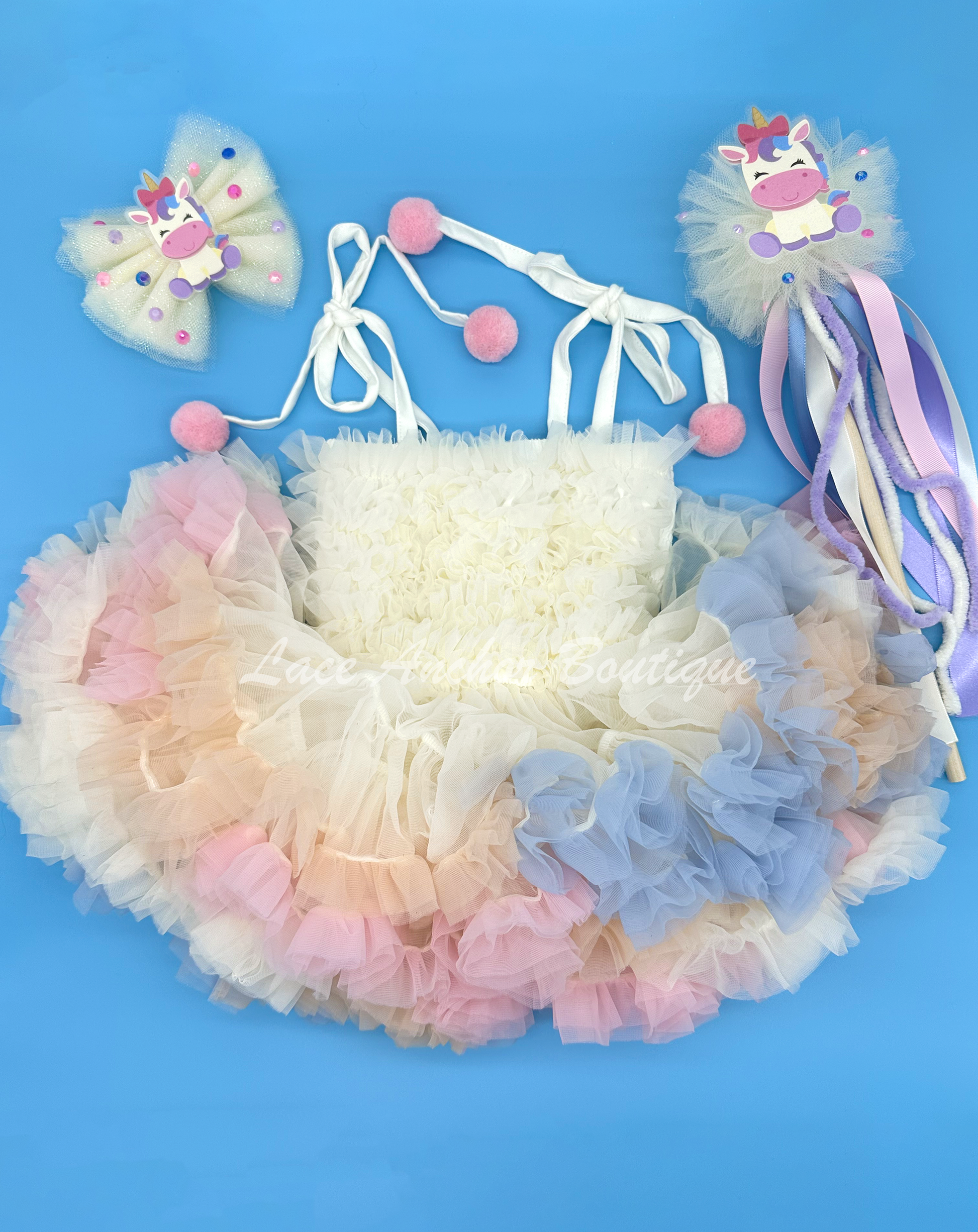 cream ivory tulle girls hair bow on barrette clip with cute pastel unicorn theme and rainbow rhinestines.