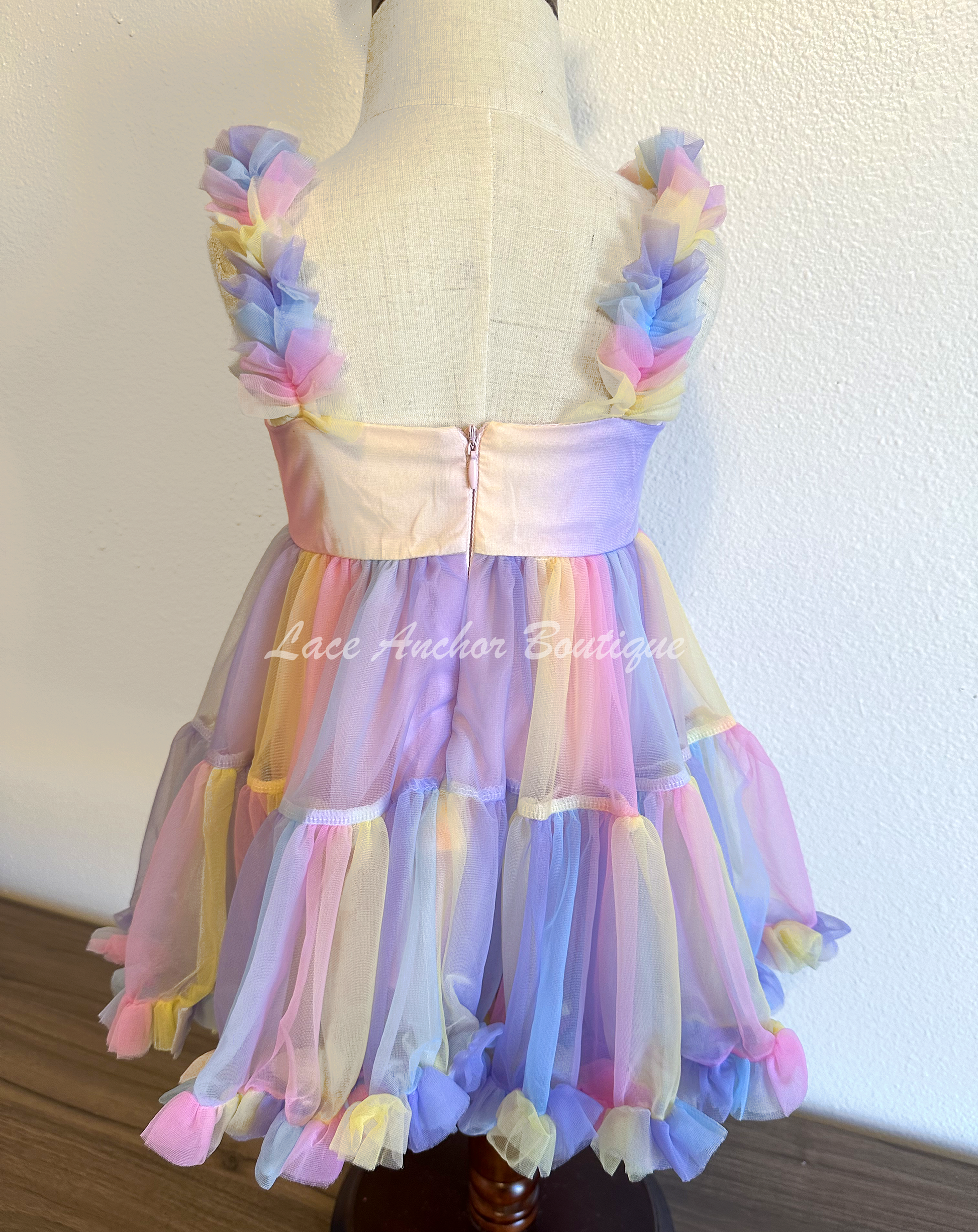 toddler youth girls pastel rainbow multi colored dress with pearl details and ruffle trim and straps. Unicorn colored theme birthday girl princess dress.