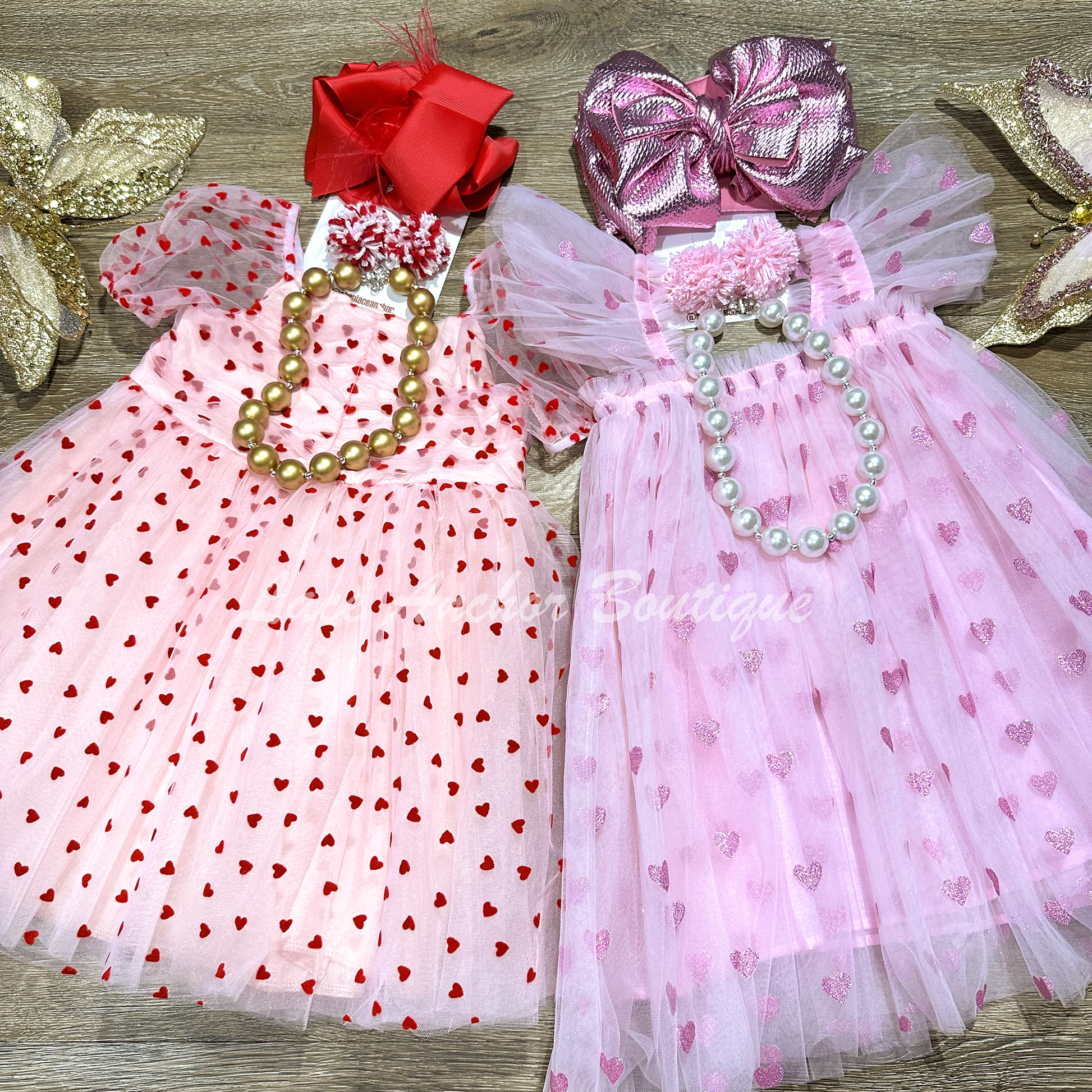 Light pink tulle tutu girls dress with glitter pink hearts and ruffled sleeves.