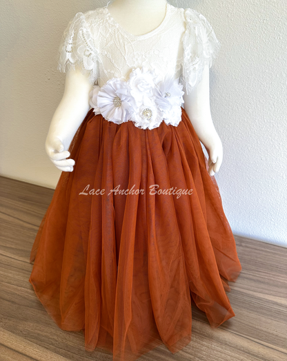flower girls maxi dress with rust copper tulle skirt, white lace top with flutter sleeves, and white floral tied sash