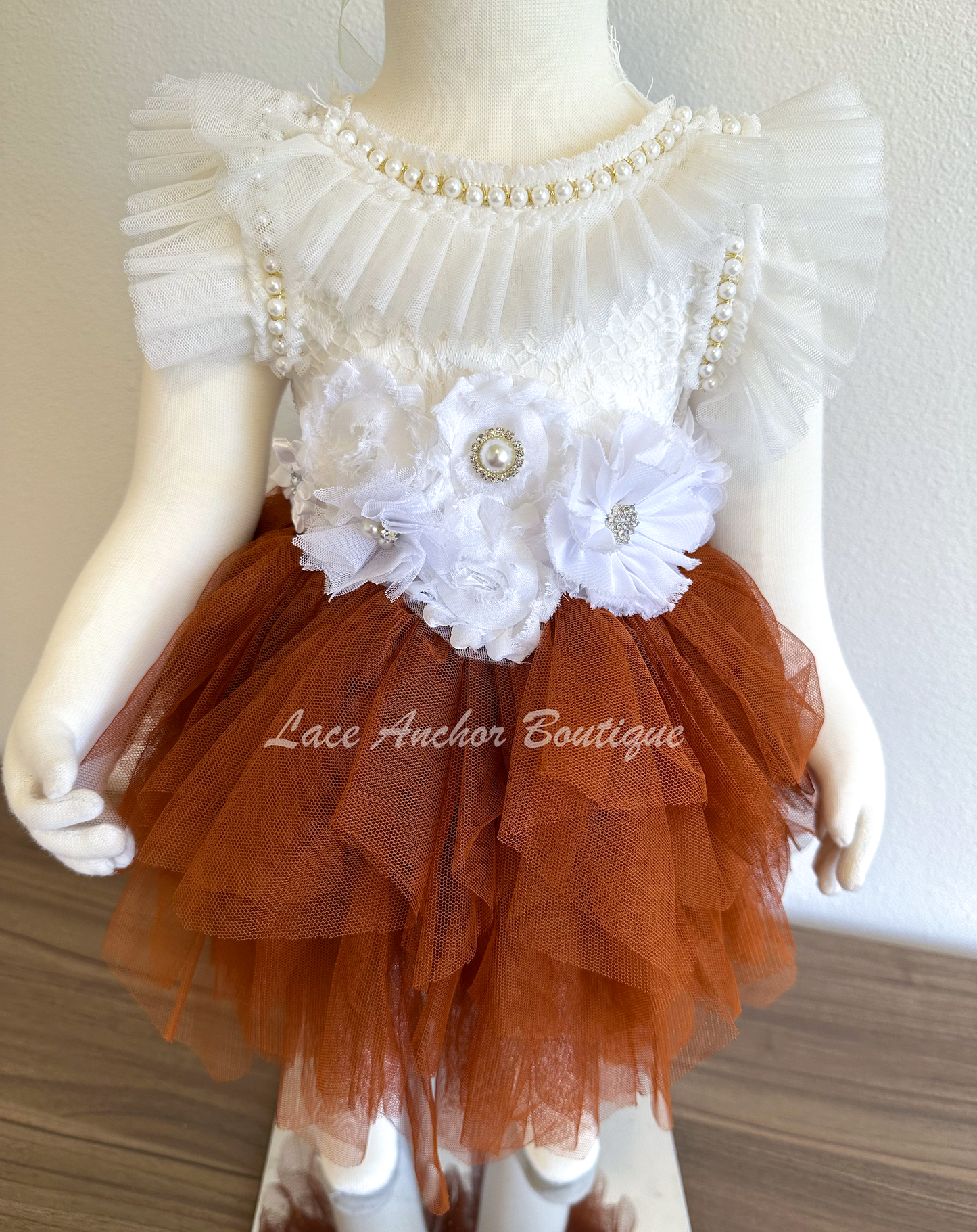 flower girls short dress with rust copper tulle skirt, white lace top with flutter sleeves, pearl beading, and white floral tied sash