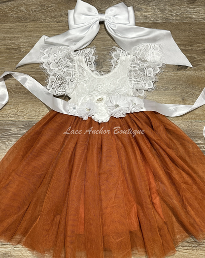 flower girls maxi dress with rust copper tulle skirt, white lace top with flutter sleeves, and white floral tied sash