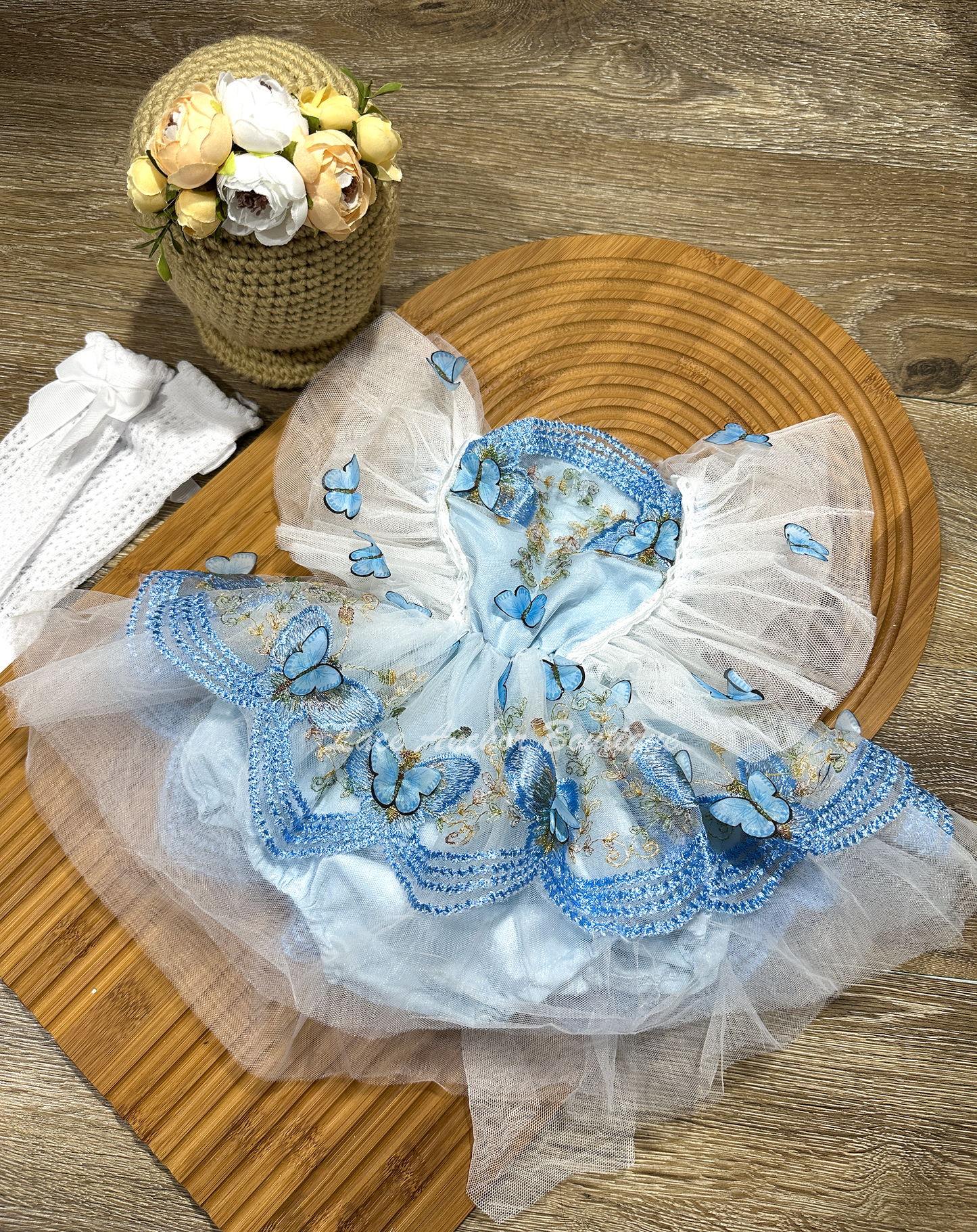 baby girls romper with flutter sleeves and skirt. Made of tulle with embroidered floral design and matching realistic butterflies all over in light blue.