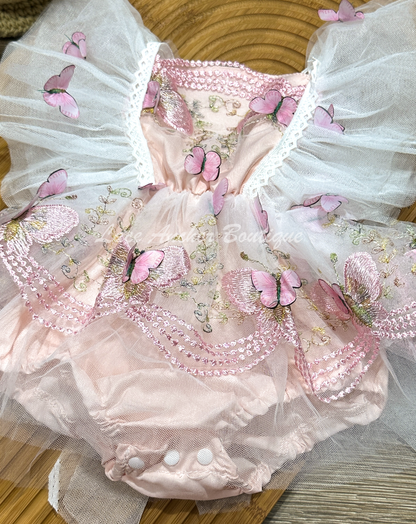 baby girls romper with flutter sleeves and skirt. Made of tulle with embroidered floral design and matching realistic butterflies all over in blush light pink.