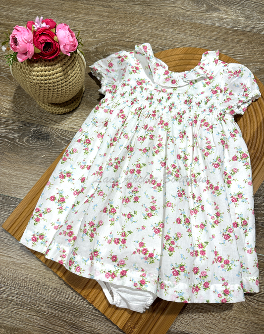 white smocked floral baby girl dress set with ruffled collar.
