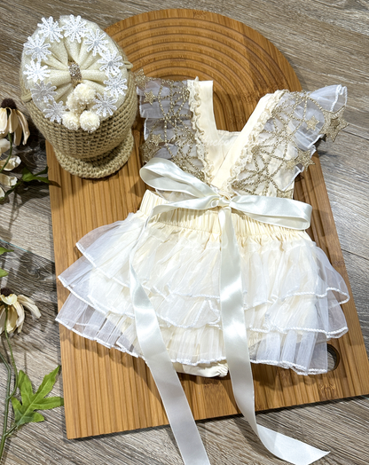 baby girls cream ivory white romper with fringe, ruffles, floral lace, embroidery, pom poms, and gold star trim. Matching hair bow set.