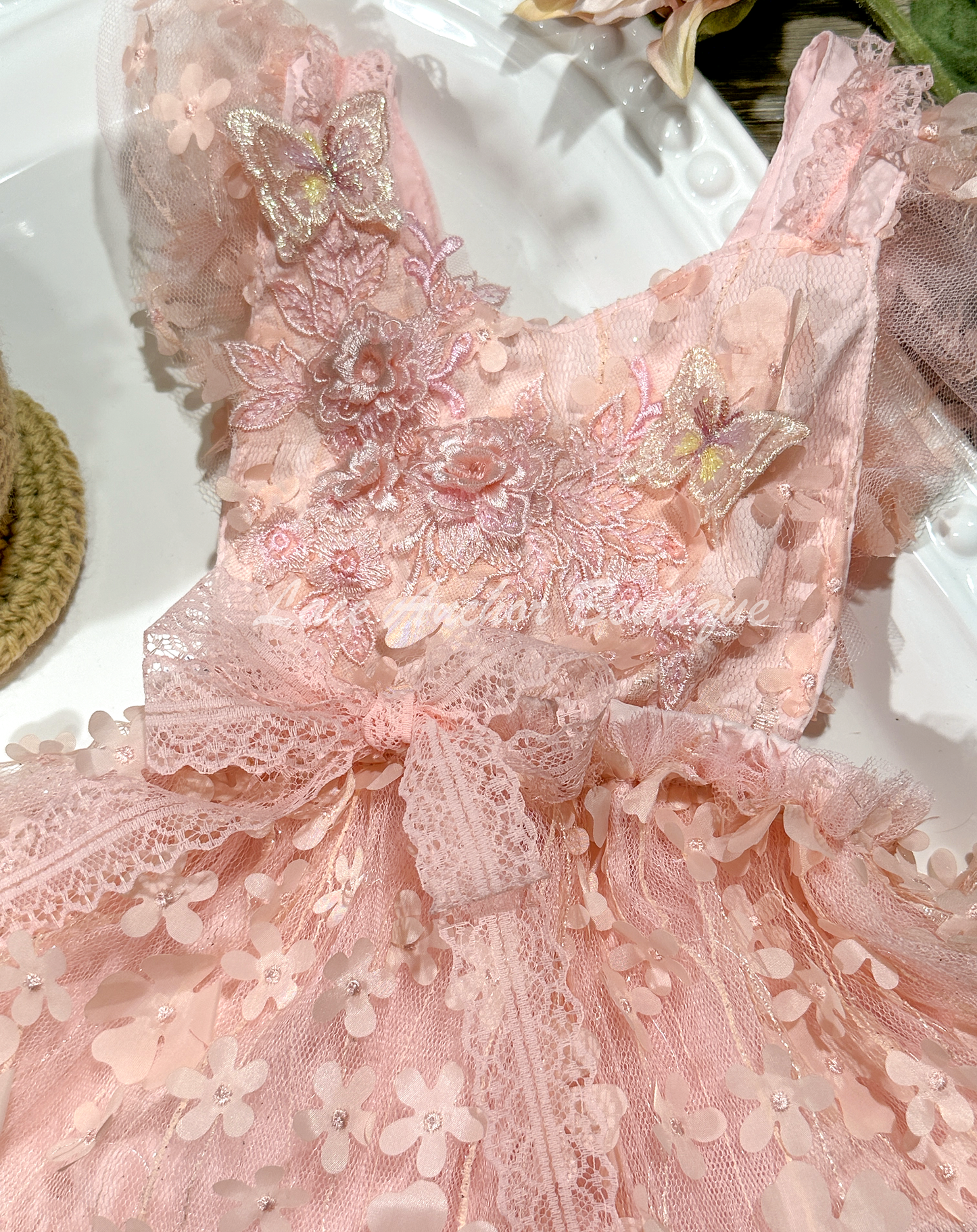 light coral pink baby girls floral tulle romper with embroidered flowers and embroidered 3d butterflies. Ruffled trim and lace bow.
