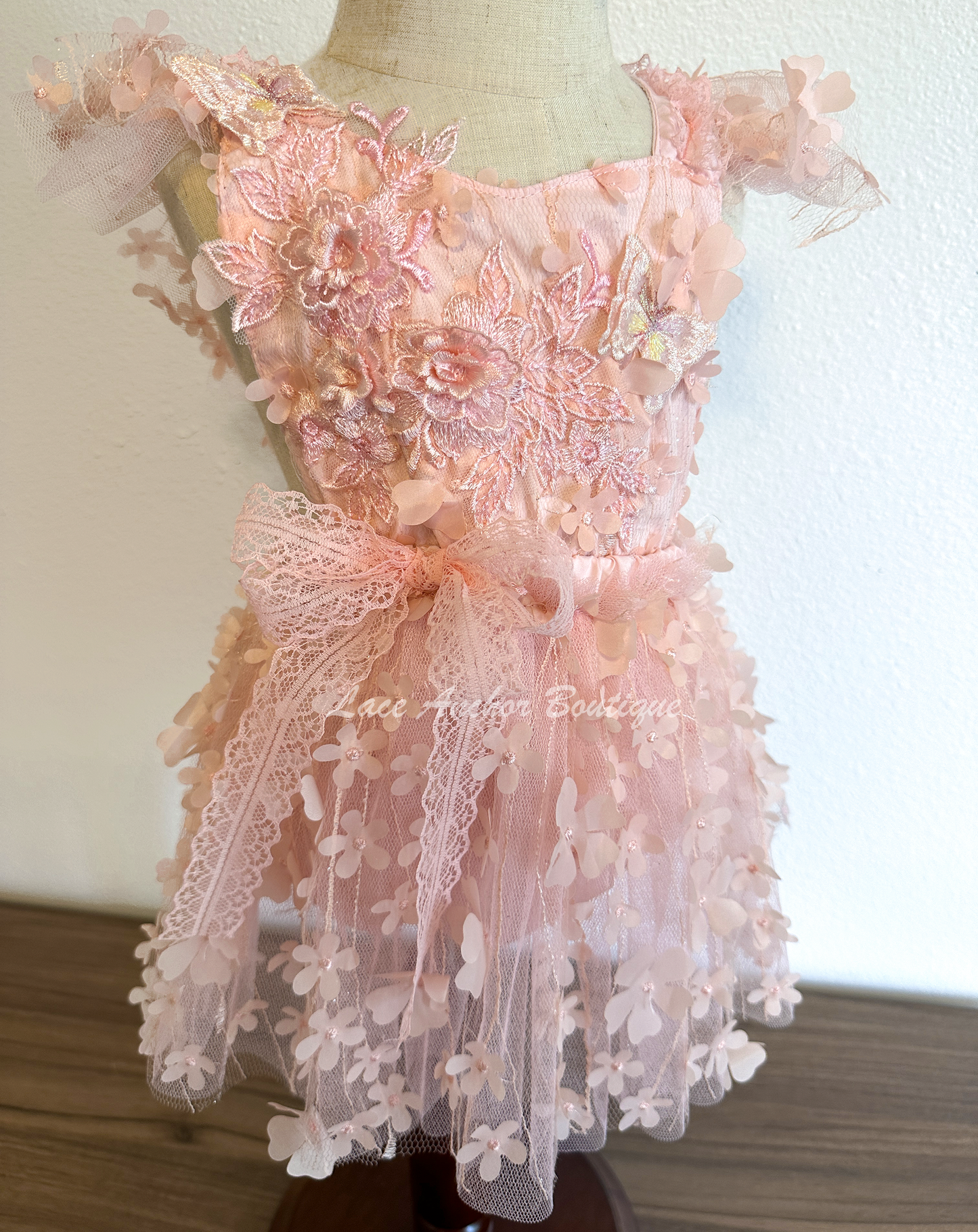 light coral pink baby girls floral tulle romper with embroidered flowers and embroidered 3d butterflies. Ruffled trim and lace bow.