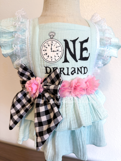 Alice in Onederland (Wonderland) themed baby girls blue romper set with gingham bow, pink flowers, and bow on nylon.