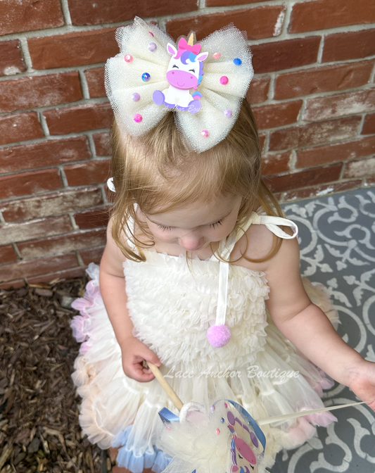 cream ivory tulle girls hair bow on barrette clip with cute pastel unicorn theme and rainbow rhinestones.