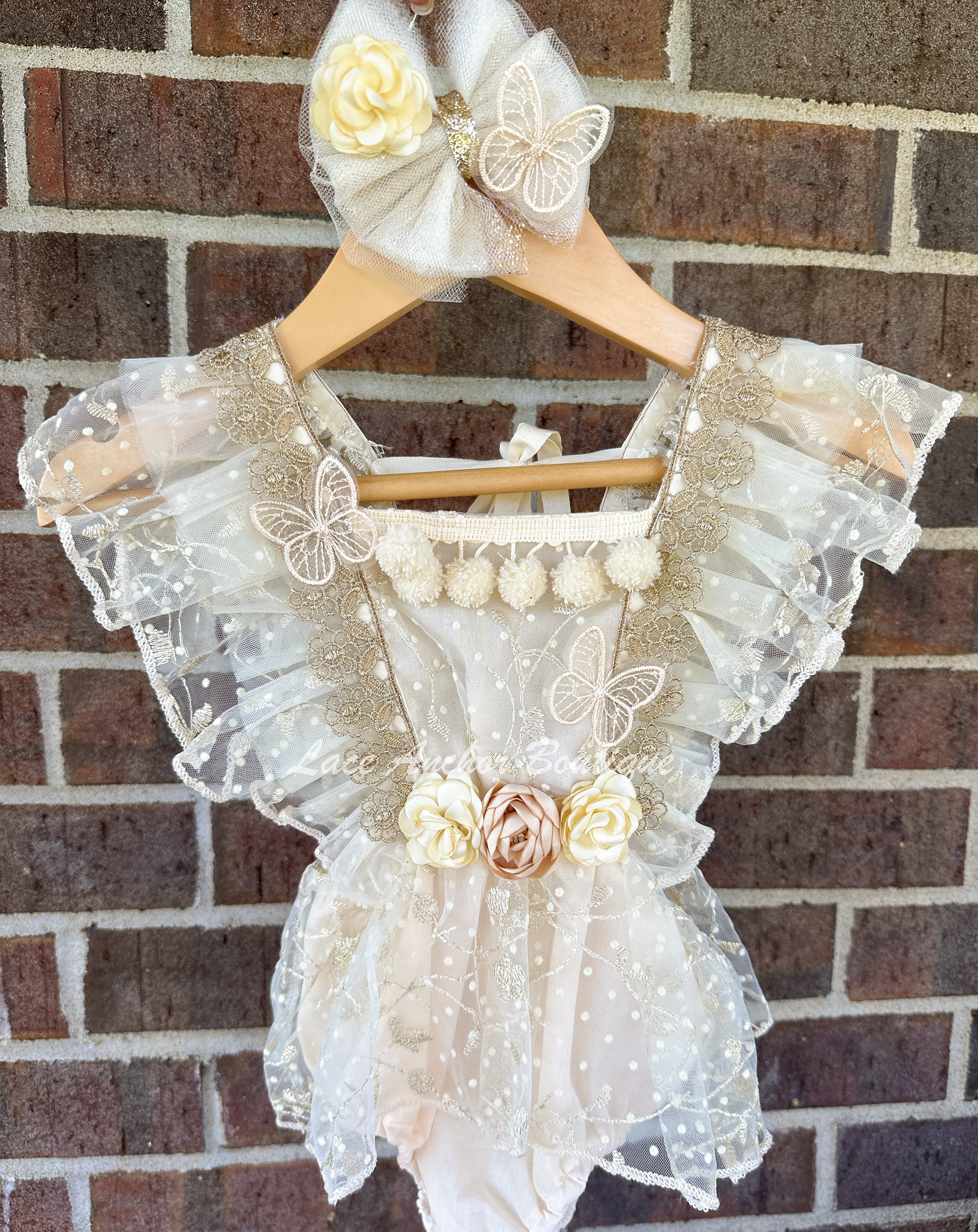 cream beige embroidered baby girls romper with golden flower details, silky d flowers, and butterflies/