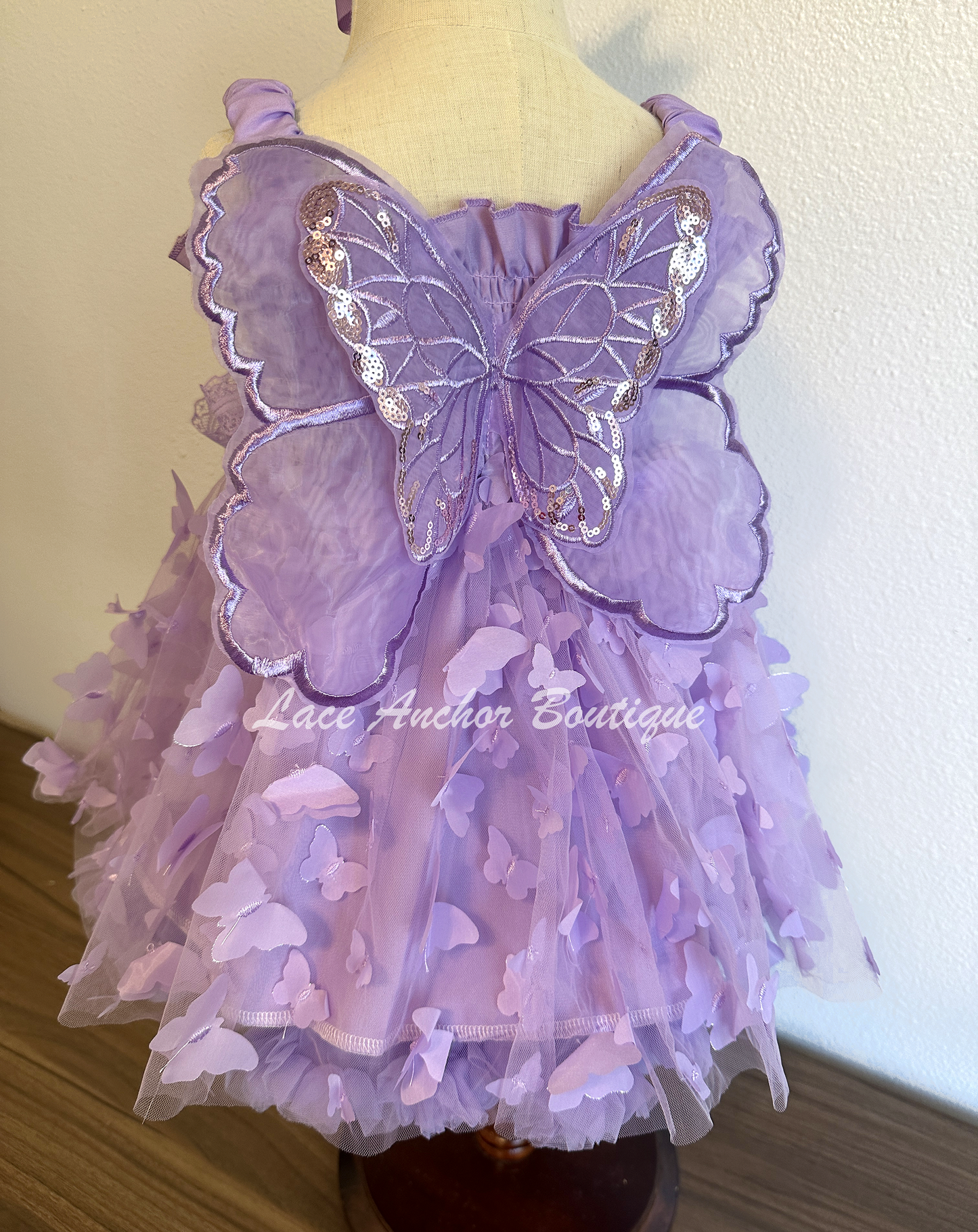 lilac purple girls butterfly wing fairy dress in pink on model child toddler. Has butterflies all over skirt.