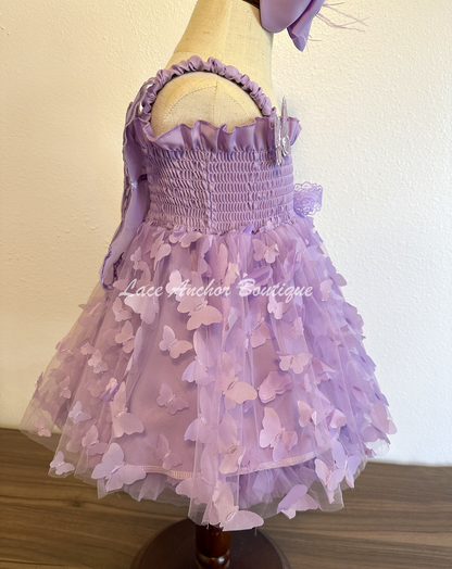 lilac purple girls butterfly wing fairy dress in pink on model child toddler. Has butterflies all over skirt.