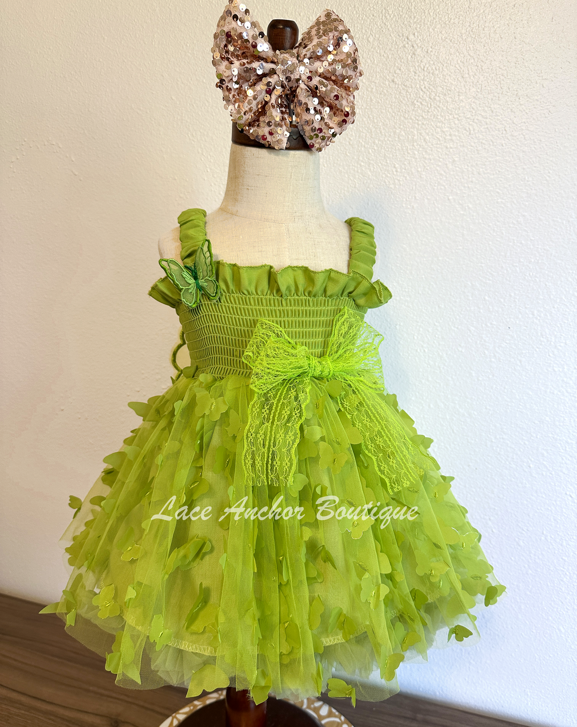 lime bright green girls butterfly wing fairy dress in pink on model child toddler. Has butterflies all over skirt.