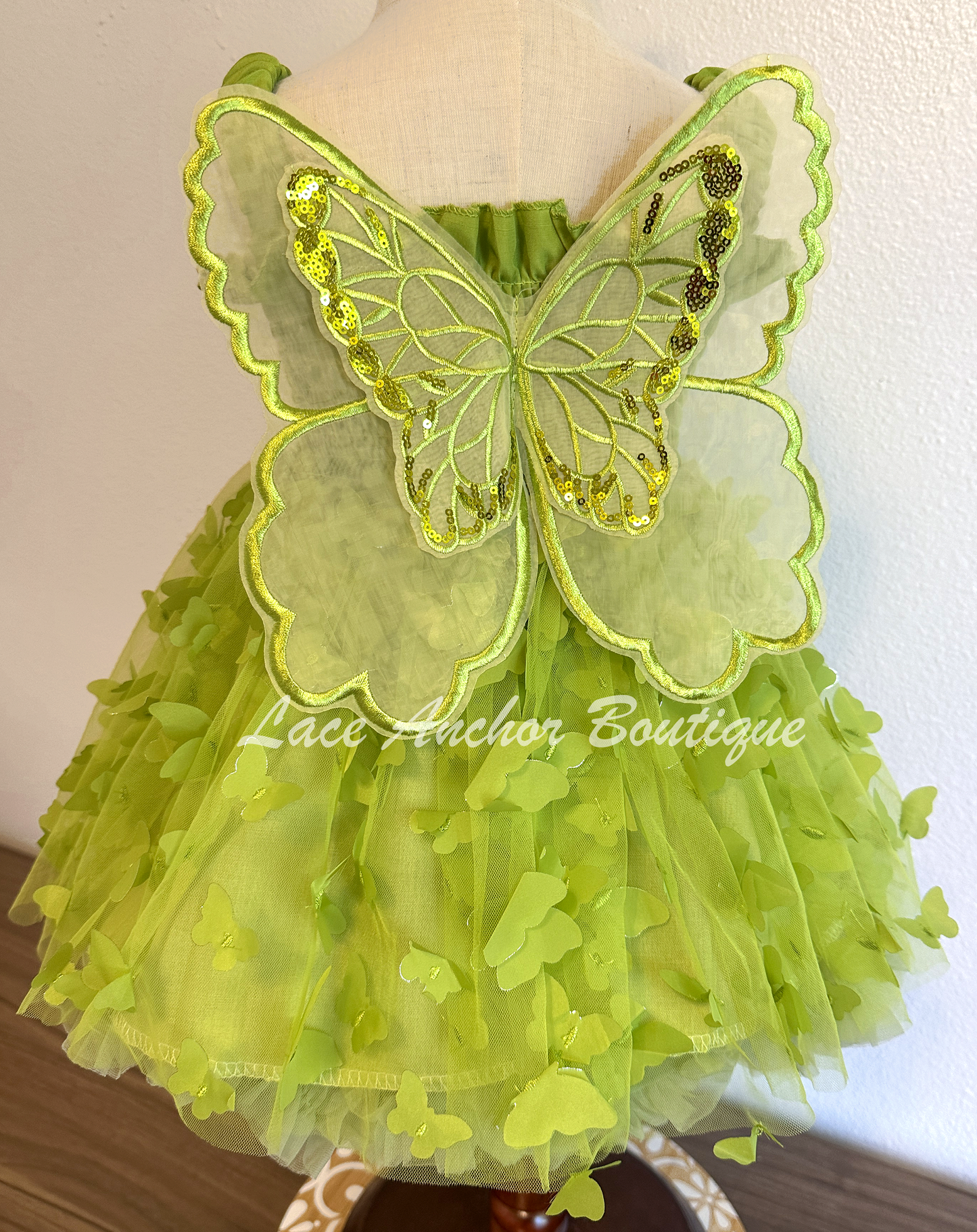 lime bright green girls butterfly wing fairy dress in pink on model child toddler. Has butterflies all over skirt.