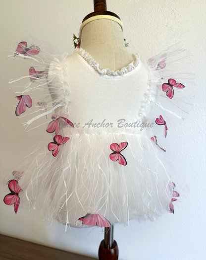 white baby girls romper with floral embroidery, tulle, lace, and butterflies all over