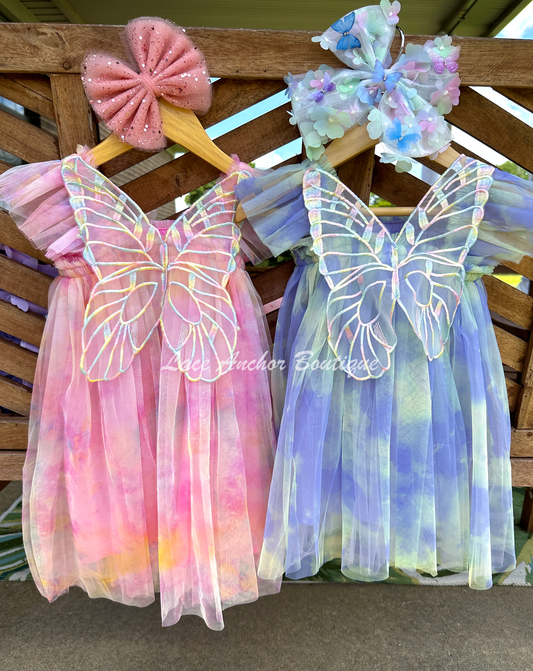 Rainbow fairy knee length tulle dresses with iridescent butterfly wings attached for toddlers, babies, kids. Dress for girls.
