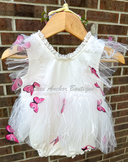 white baby girls romper with floral embroidery, tulle, lace, and butterflies all over