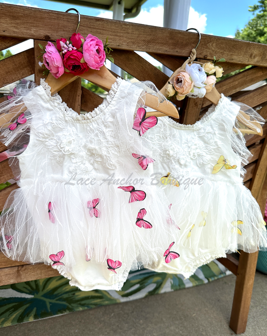 white baby girls romper with floral embroidery, tulle, lace, and butterflies all over