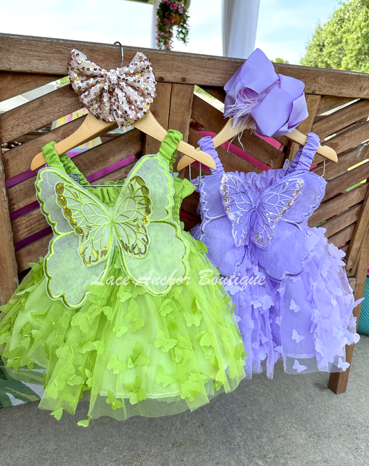 lilac purple or lime bright green girls butterfly wing fairy dress in pink on model child toddler. Has butterflies all over skirt.
