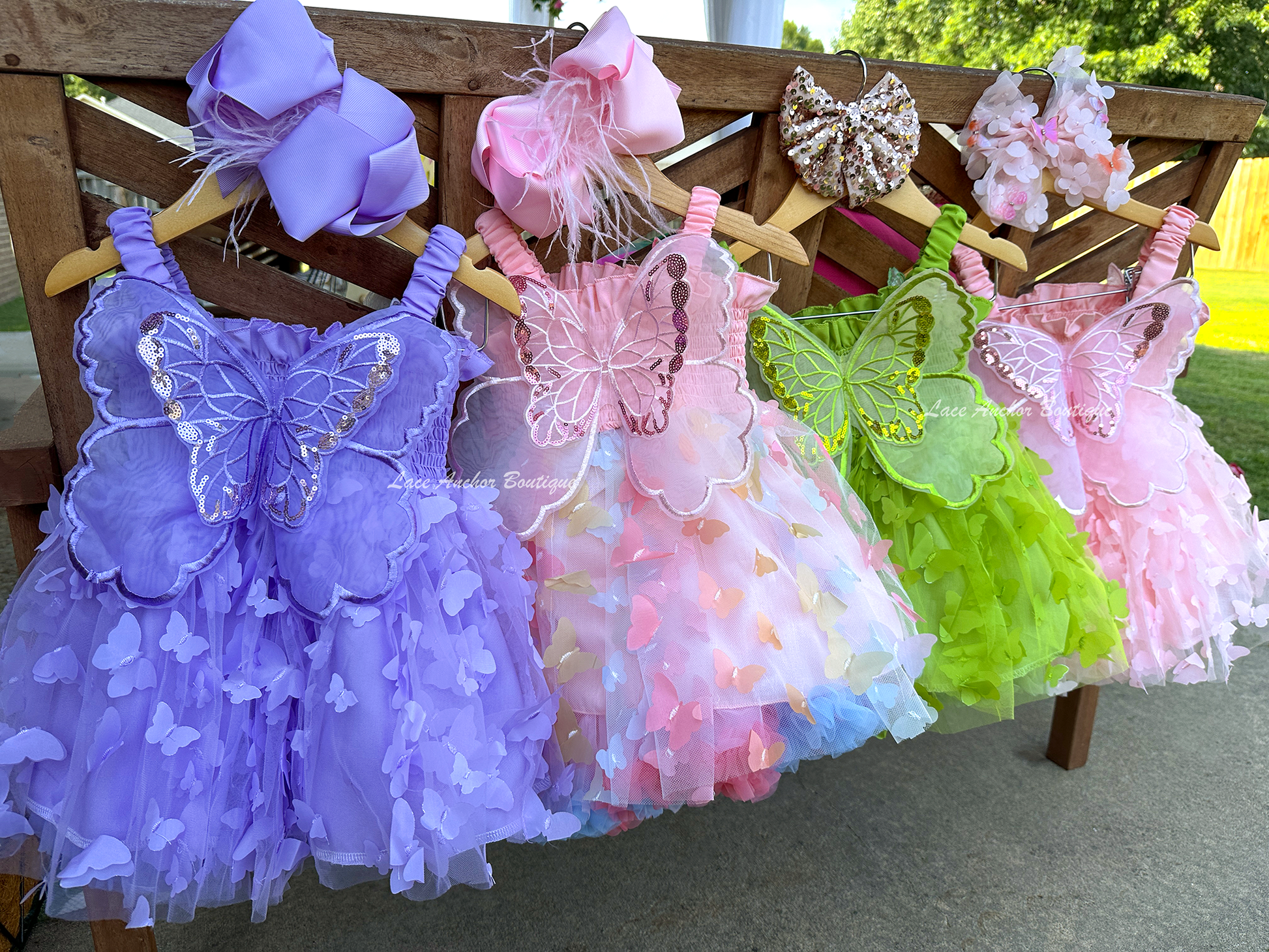 lilac purple or lime bright green girls butterfly wing fairy dress in pink on model child toddler. Has butterflies all over skirt.