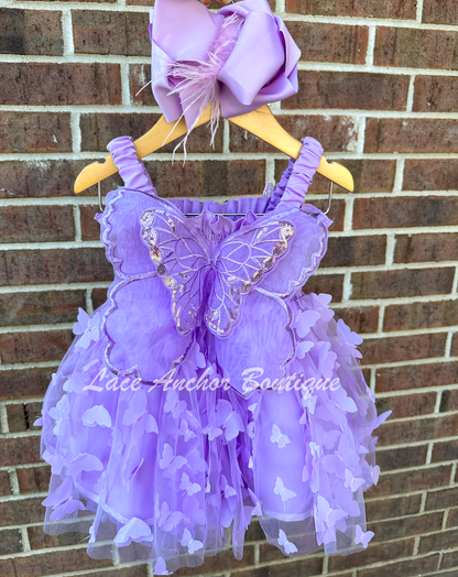 lilac purple girls butterfly wing fairy dress in pink on model child toddler. Has butterflies all over skirt.