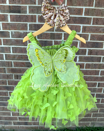 lime bright green girls butterfly wing fairy dress in pink on model child toddler. Has butterflies all over skirt.