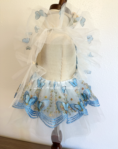 baby girls romper with flutter sleeves and skirt. Made of tulle with embroidered floral design and matching realistic butterflies all over in light blue.