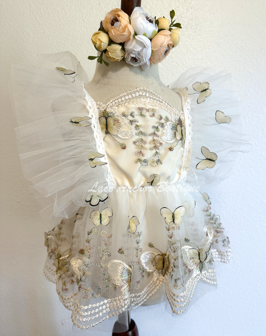 baby girls romper with flutter sleeves and skirt. Made of tulle with embroidered floral design and matching realistic butterflies all over in white and cream.