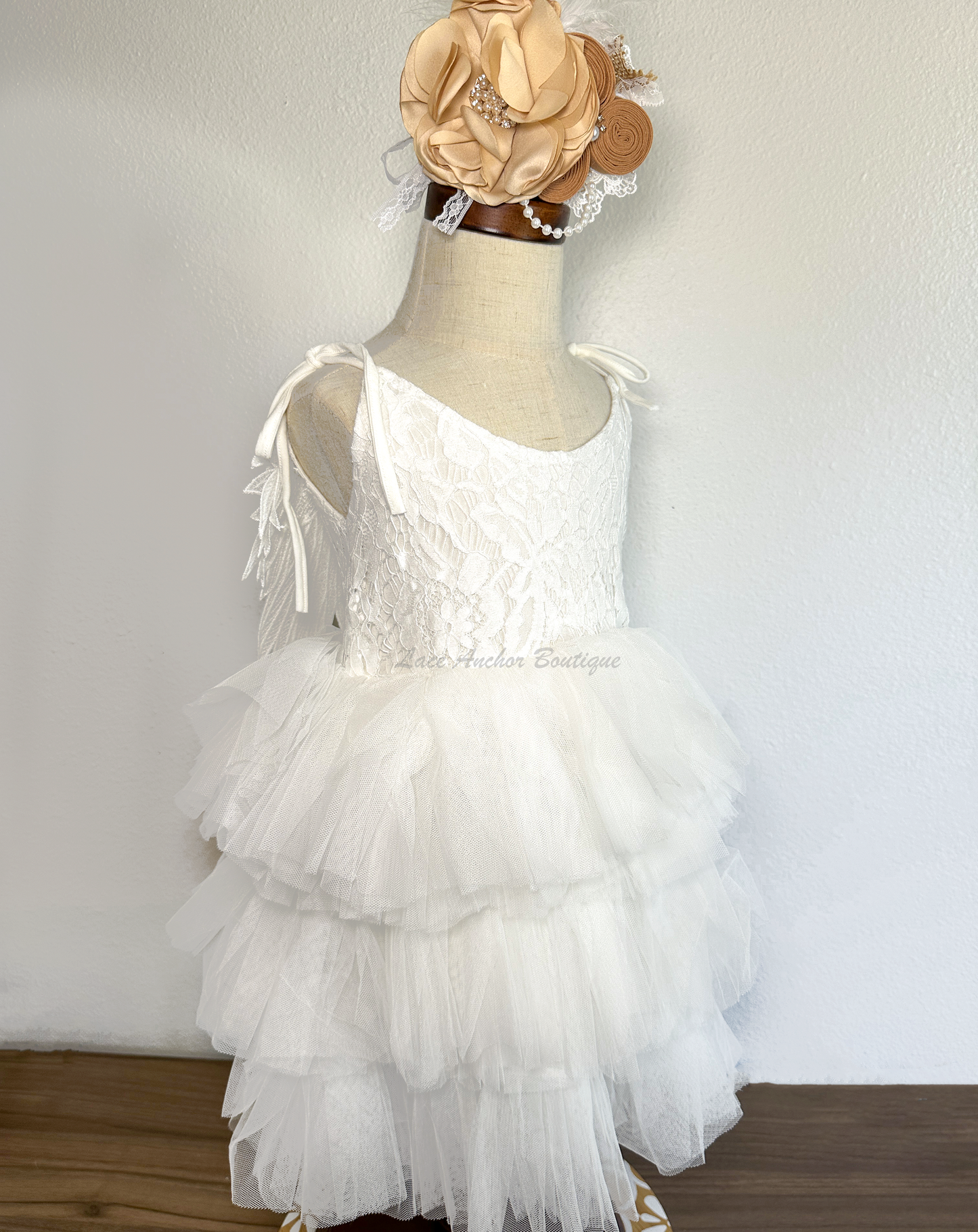 all white girls dress with layered ruffled tulle skirt, lace top, tied shoulders, and embroidered angel wings on backside.