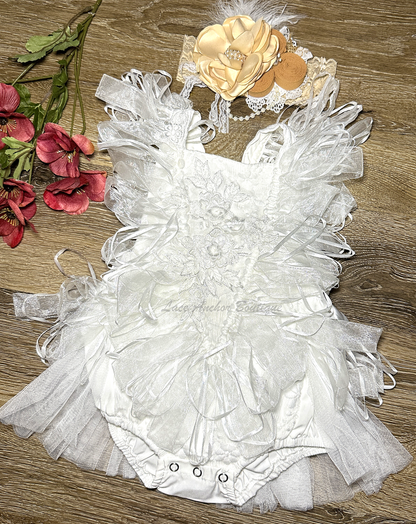 white baby girls romper with tulle half skirt, ribbon loop details, and embroidered floral applique across front