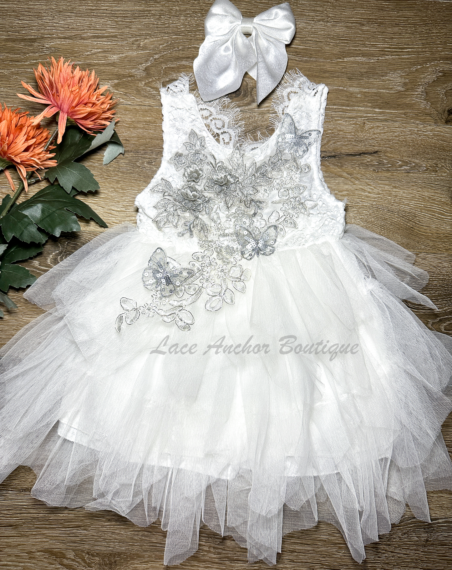 white girls dress with embroidered floral applique in silver with pearls and silver sequin butterflies