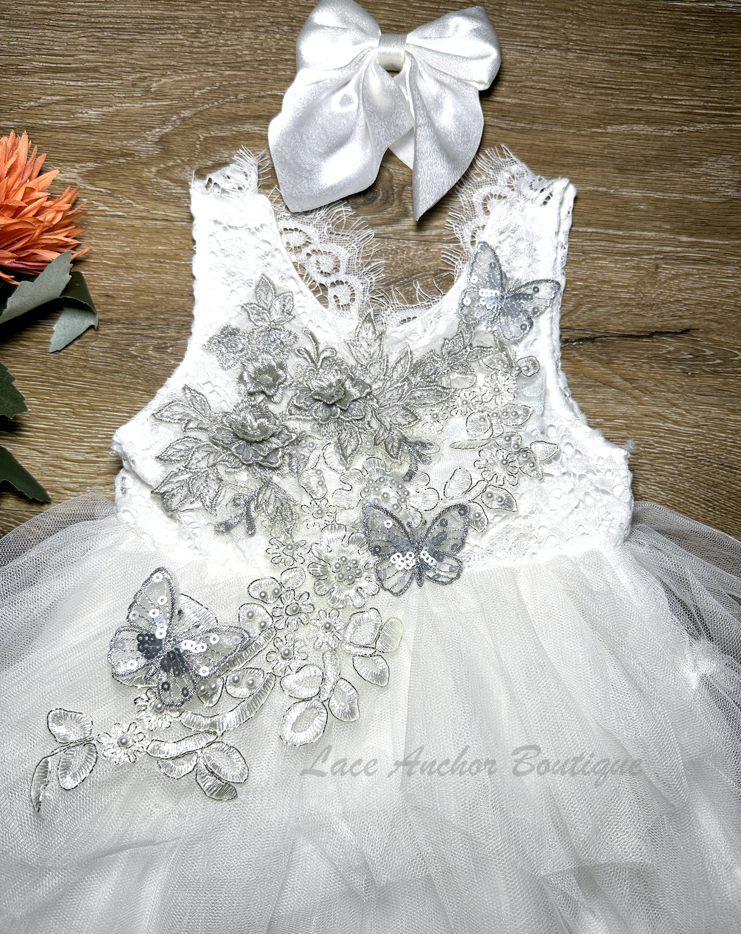 white girls dress with embroidered floral applique in silver with pearls and silver sequin butterflies