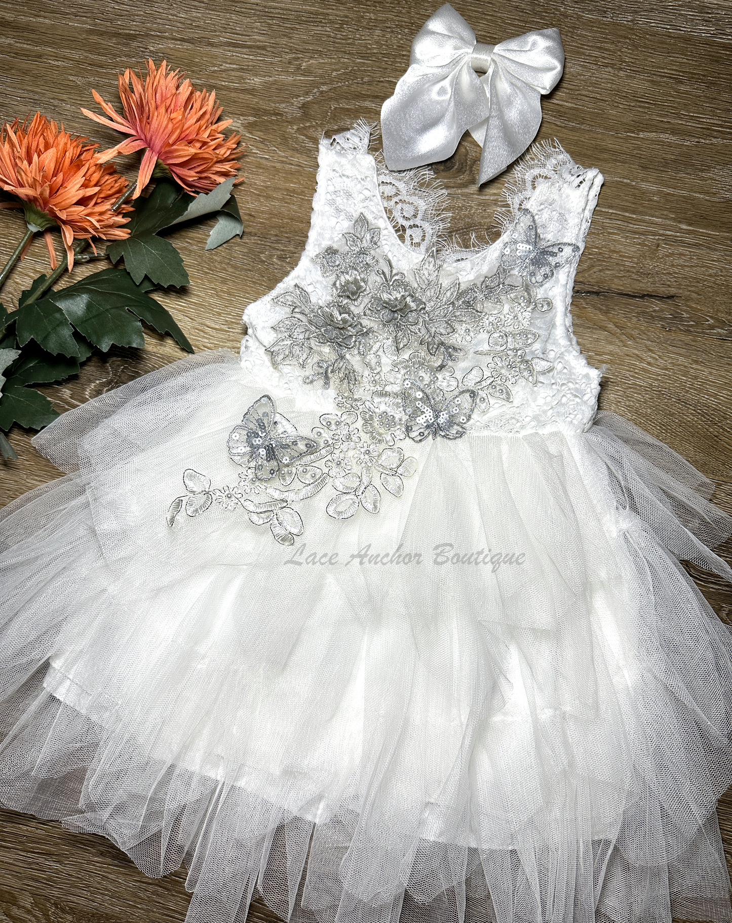 white girls dress with embroidered floral applique in silver with pearls and silver sequin butterflies