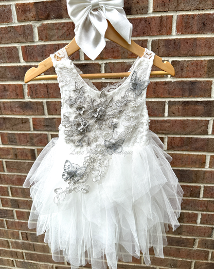 white girls dress with embroidered floral applique in silver with pearls and silver sequin butterflies