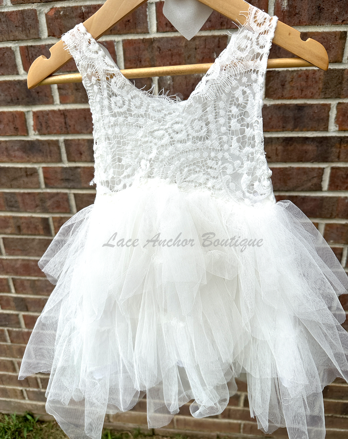 white girls dress with embroidered floral applique in silver with pearls and silver sequin butterflies