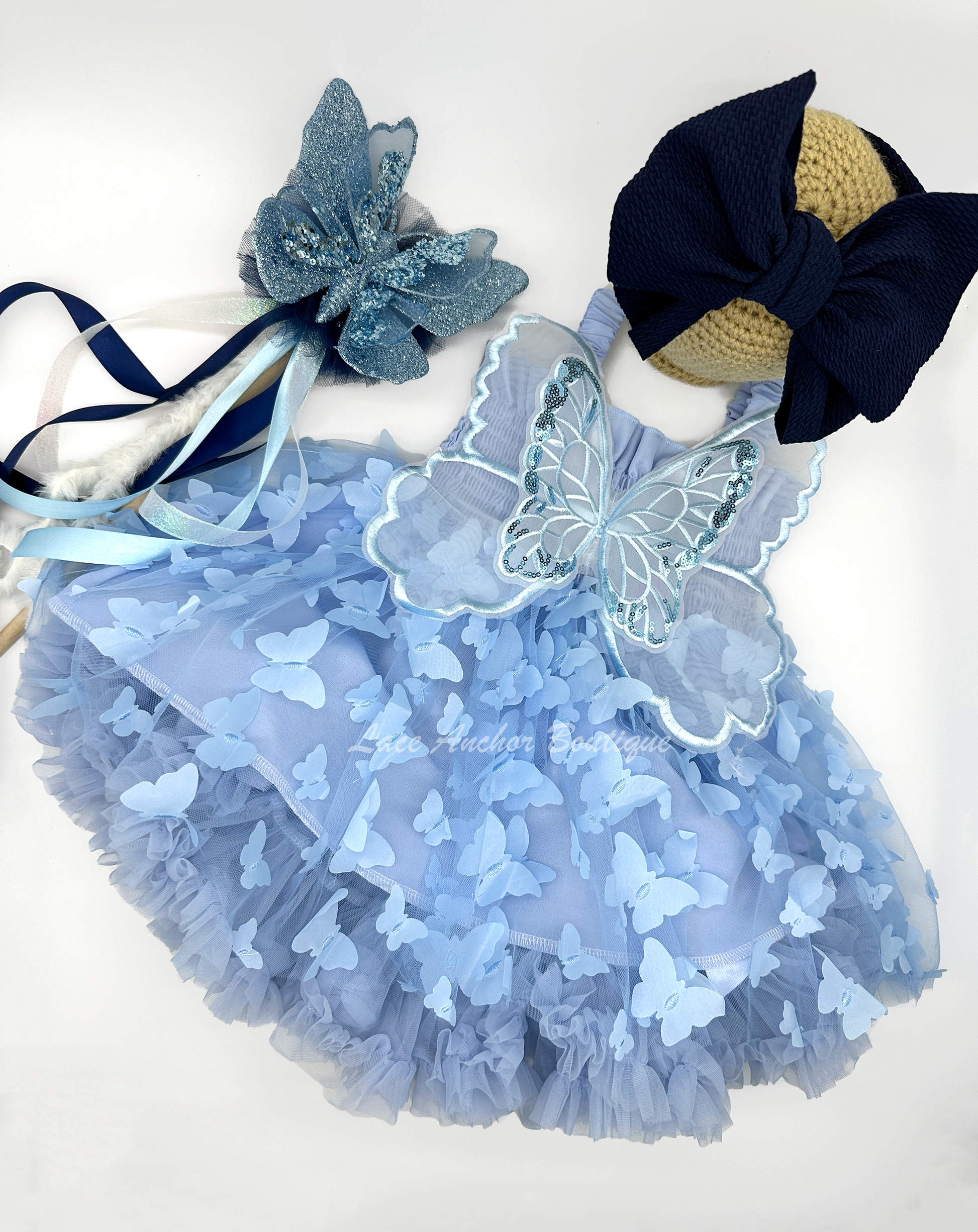 light blue girls butterfly wing fairy dress in pink on model child toddler. Has butterflies all over skirt.