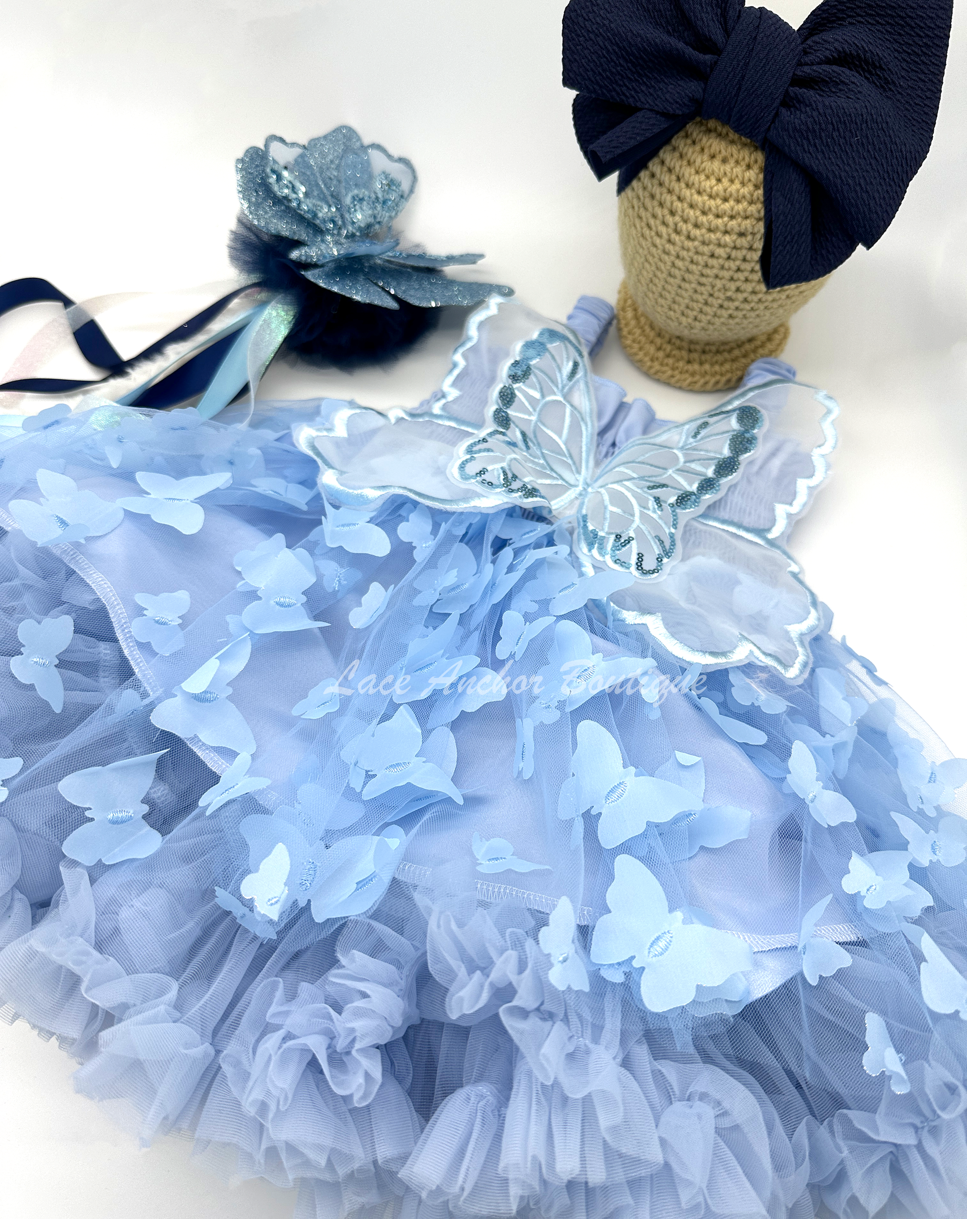 light blue girls butterfly wing fairy dress in pink on model child toddler. Has butterflies all over skirt.