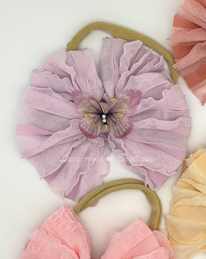 baby and toddler ruffle frilly bow on nylon band with butterfly center in lilac purple