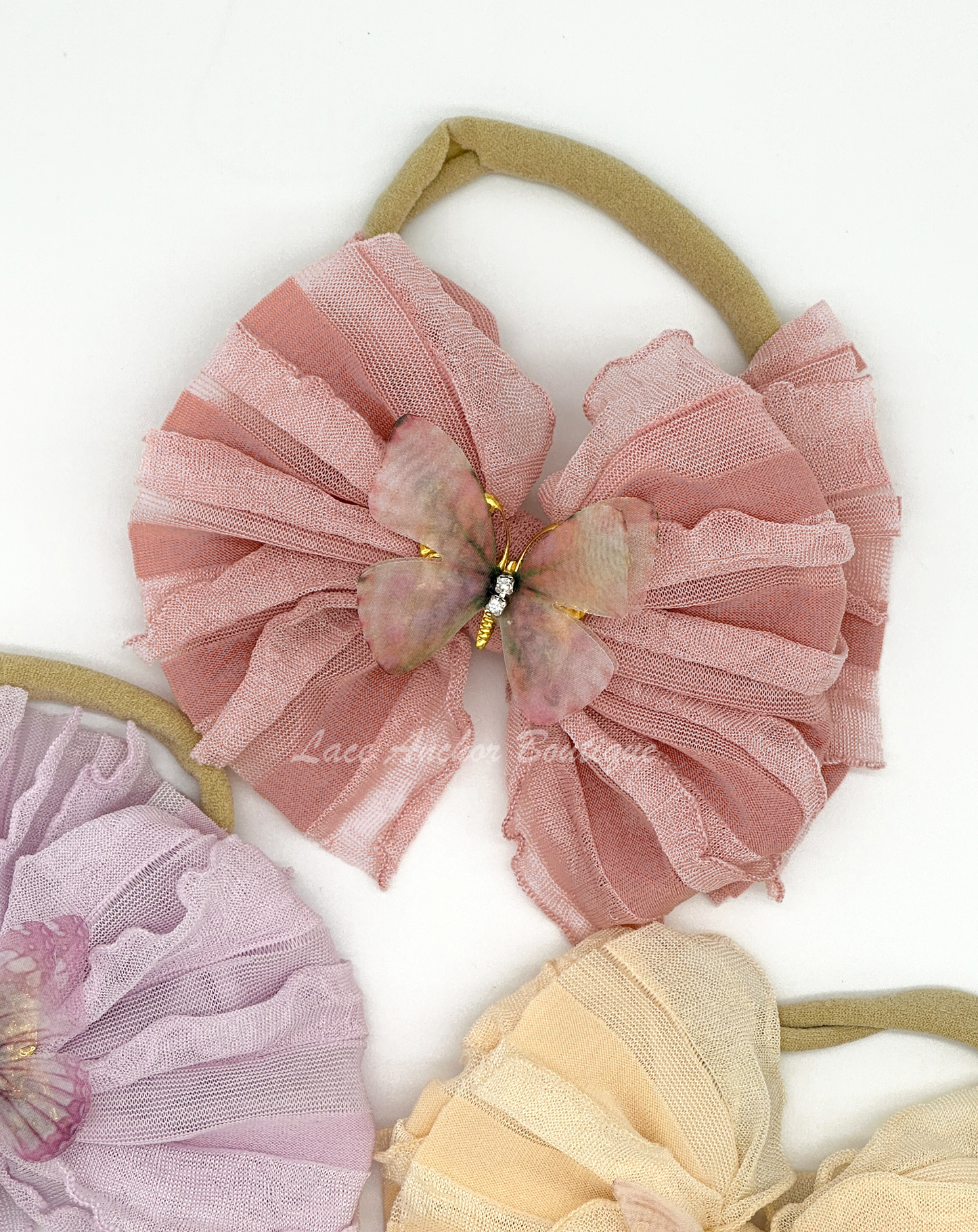 baby and toddler ruffle frilly bow on nylon band with butterfly center in mauve pink