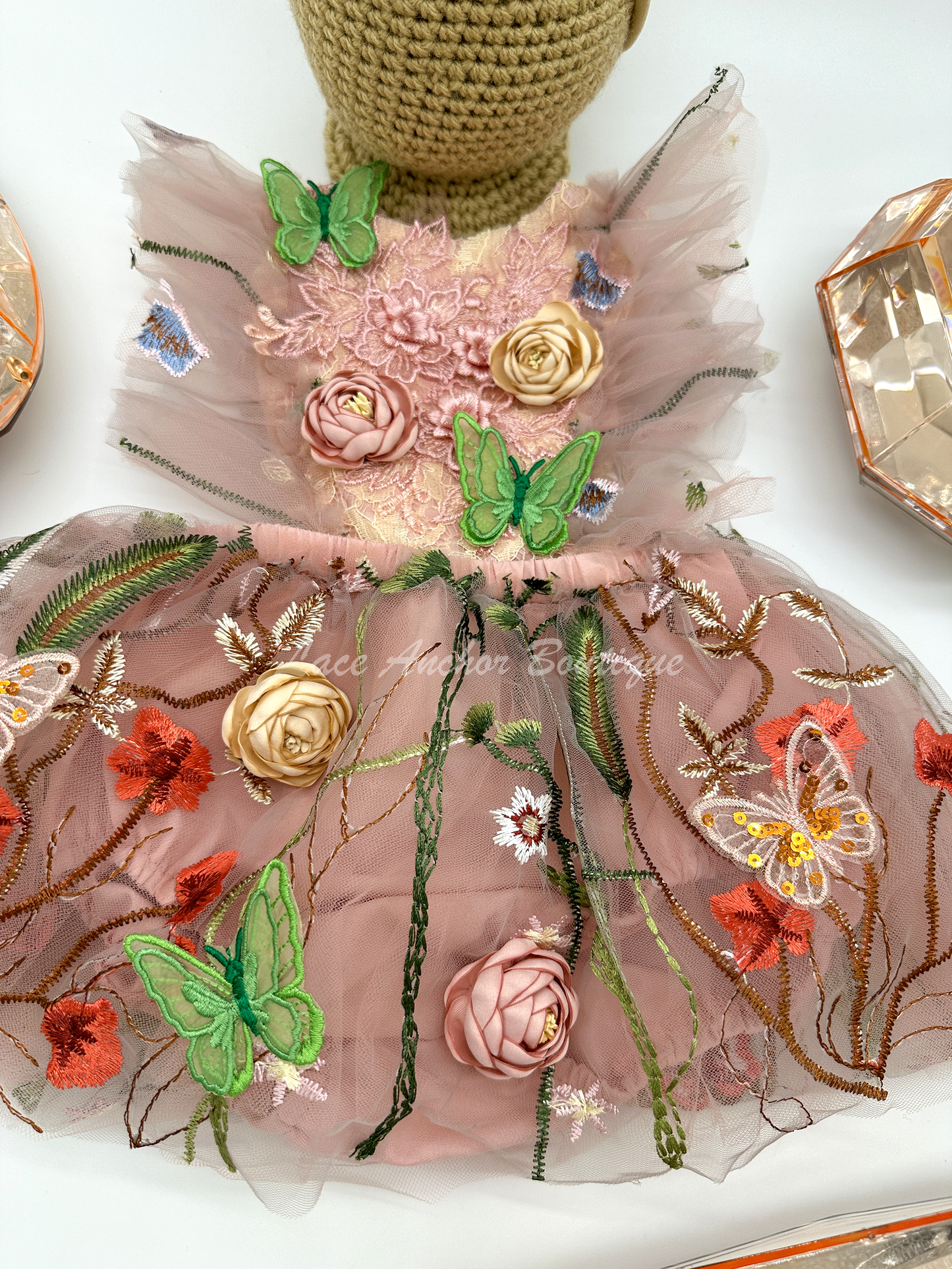 mauve pink baby girl romper. Lace tulle romper dress with flutter sleeves, 3D embroidered flowers, embroidered green butterflies, and bronze sequin butterflies.