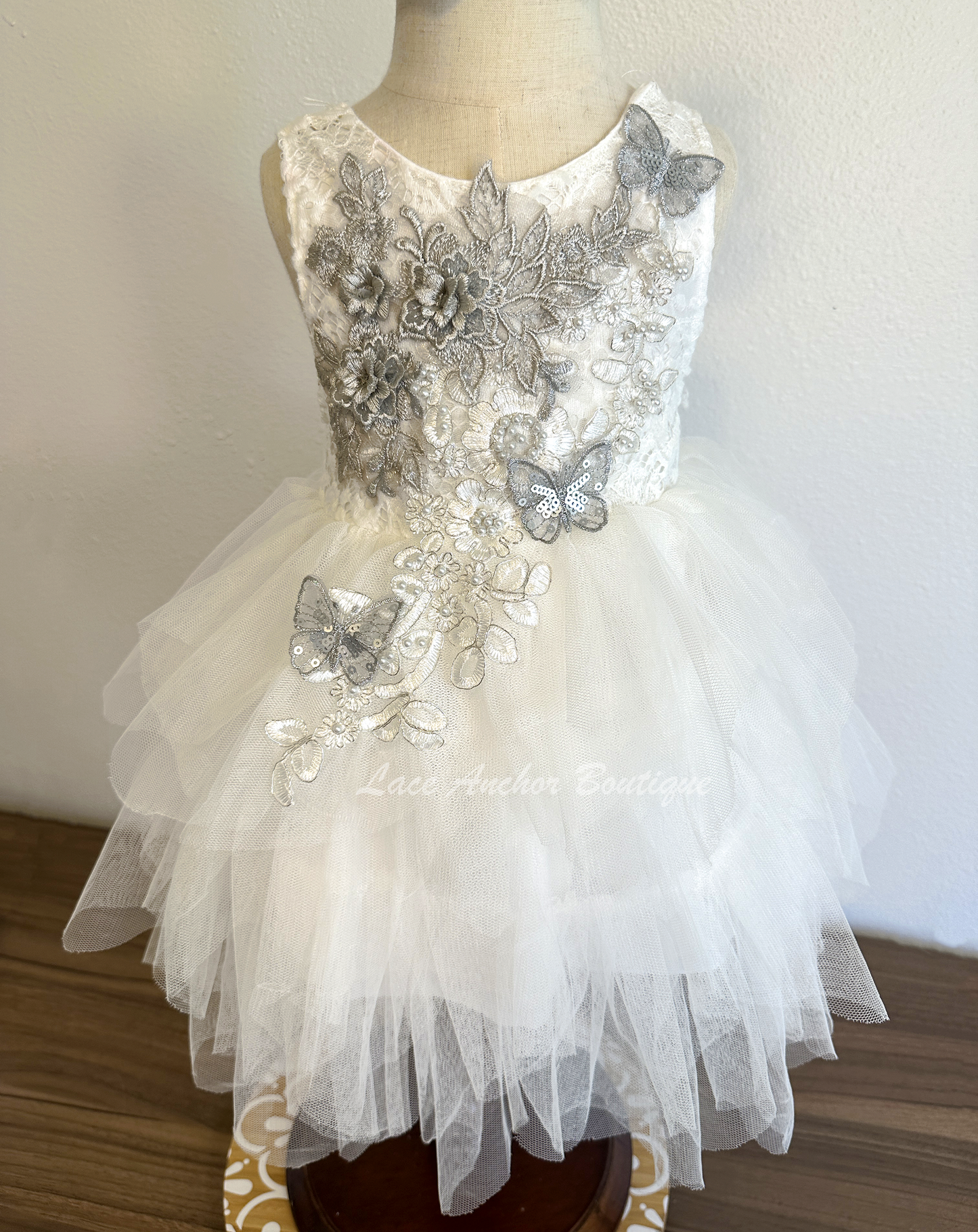 white girls dress with embroidered floral applique in silver with pearls and silver sequin butterflies