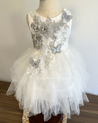 white girls dress with embroidered floral applique in silver with pearls and silver sequin butterflies