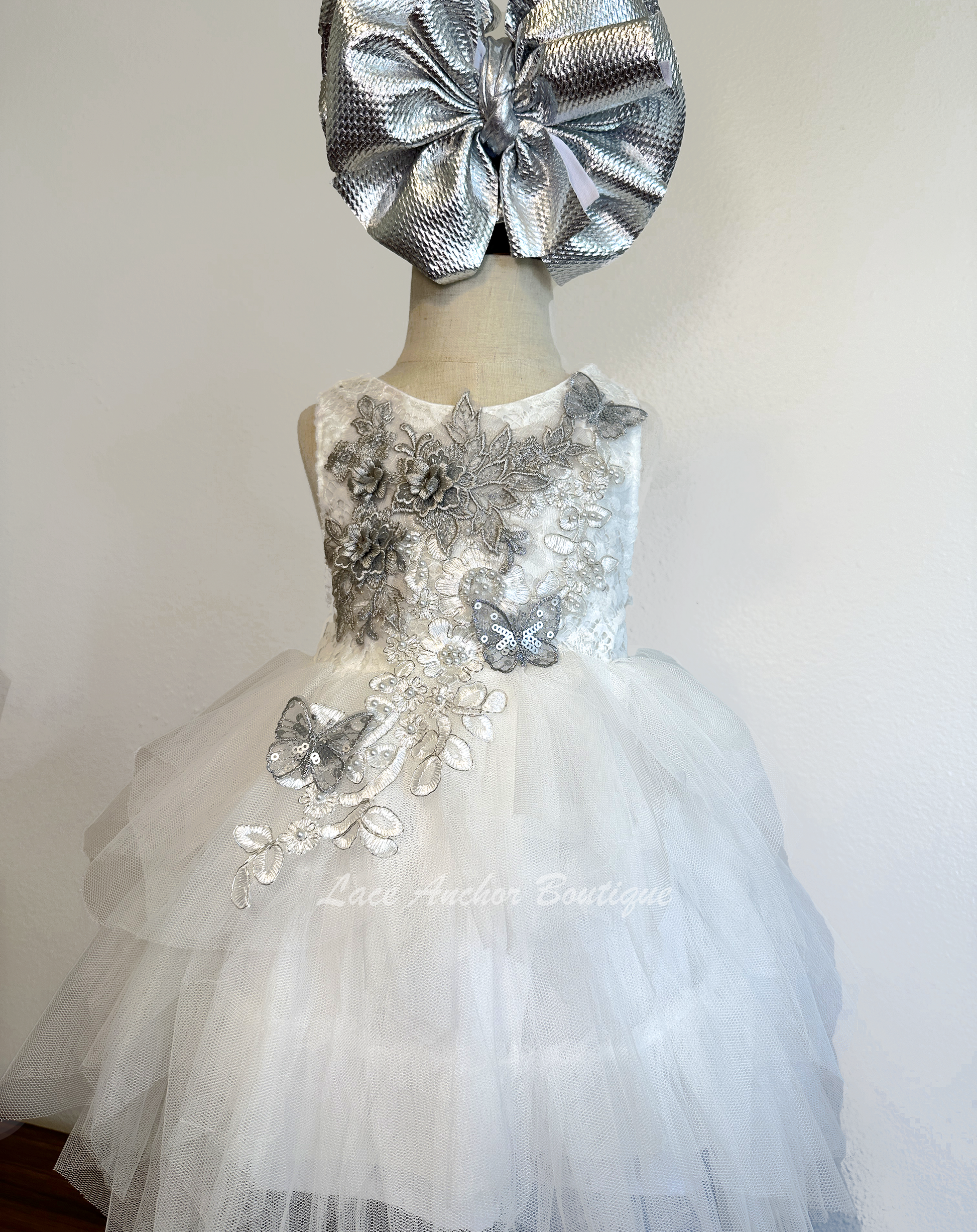 white girls dress with embroidered floral applique in silver with pearls and silver sequin butterflies