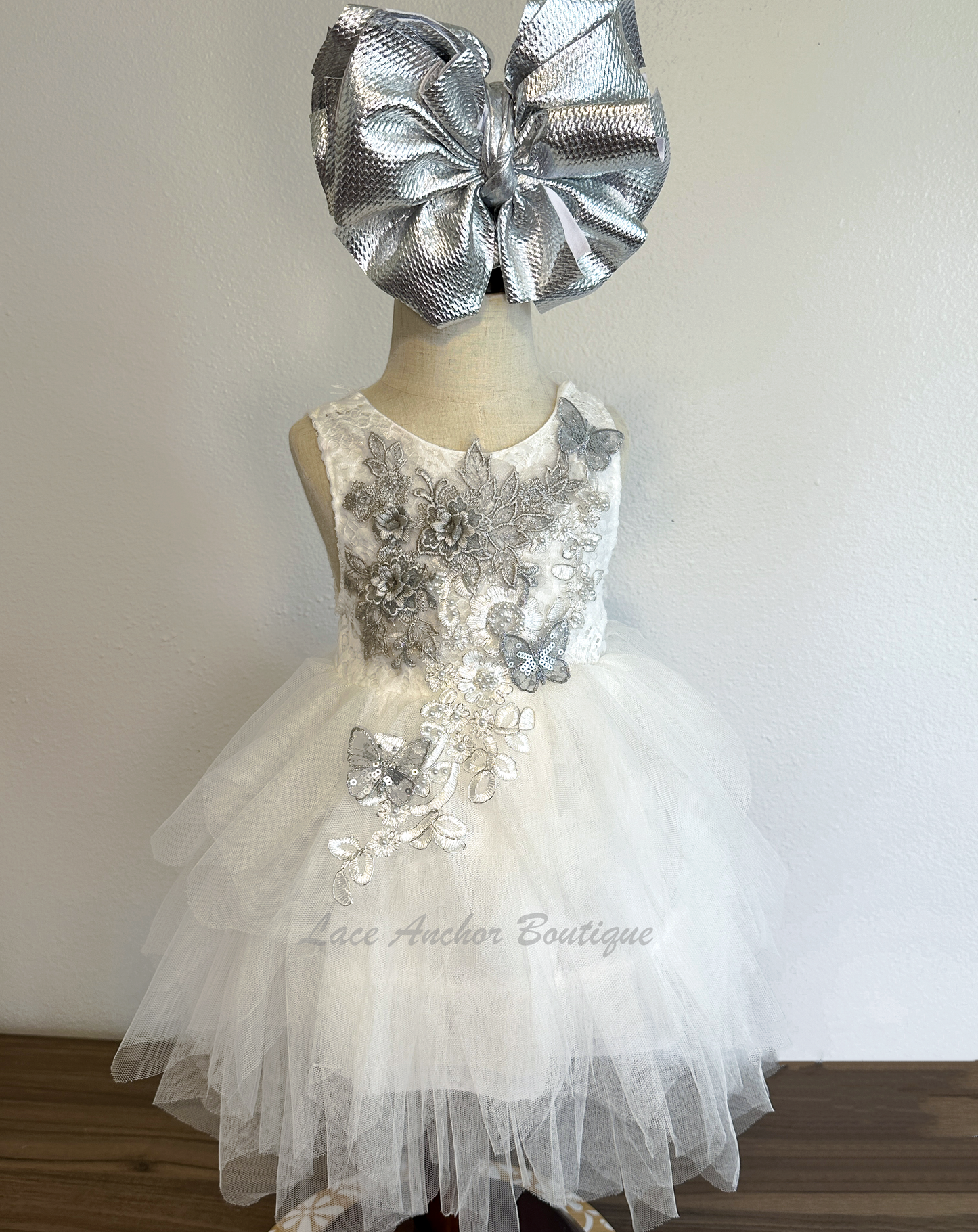 white girls dress with embroidered floral applique in silver with pearls and silver sequin butterflies